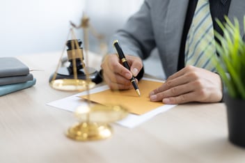 Photo of a Person Signing Paper